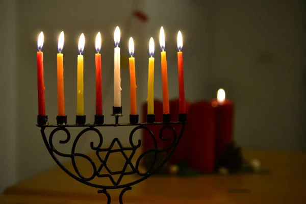 Chanukkiah, eight armed menorah for Chanukka Jewish feast, candle lighting and Christmas candles — Stock Photo, Image