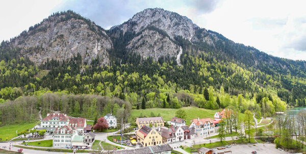 view of the mountains in front of the lake Alpsee and surroundings in Bavaria Stitched Panorama