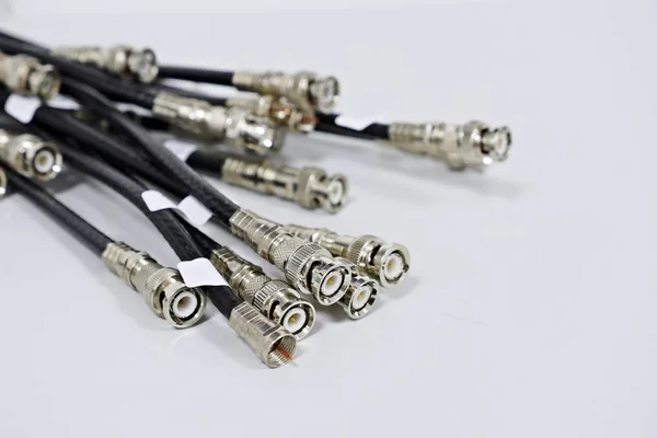 BNC jack with black cable for video signal or CCTV signal on white background.