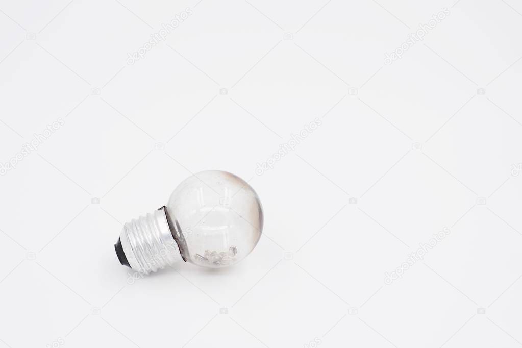 Burned light bulb on white background