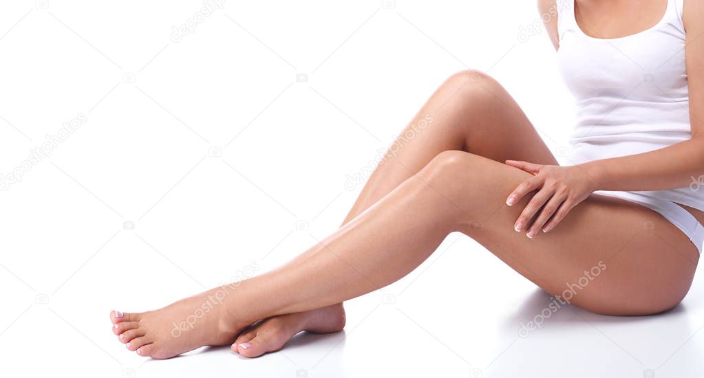 The legs of a young girl, part of the female body, tanned skin, body care, female legs isolated on white background, healthy and clean skin, health care, girl in underwear, french pedicure.