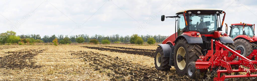 Tractor working on the farm, agrarian industry, a modern agricultural transport, cultivation of fertile land, tractor on cloudy sky background, agricultural machine