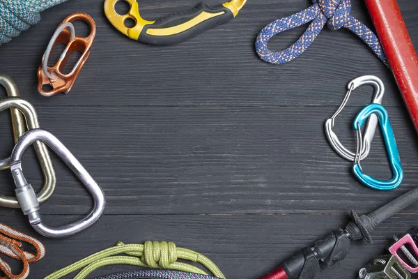 climbing equipment on a wooden black background