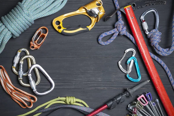 climbing equipment on a wooden black background