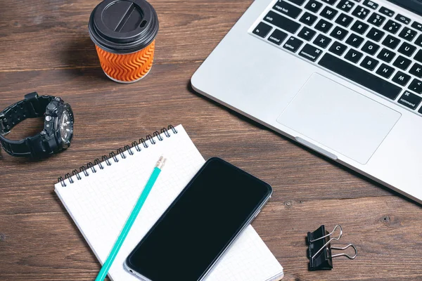 modern business tools on a brown wooden background