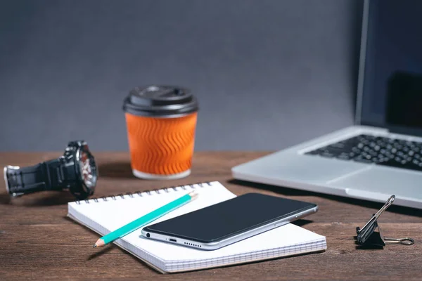 modern business tools on a brown wooden background