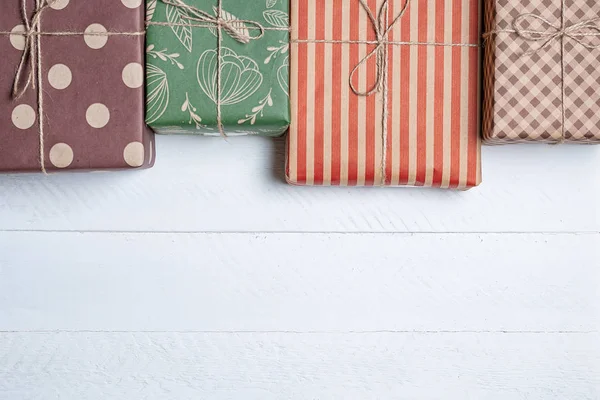 colorful boxes with gifts on a white wooden background with a place for copy space