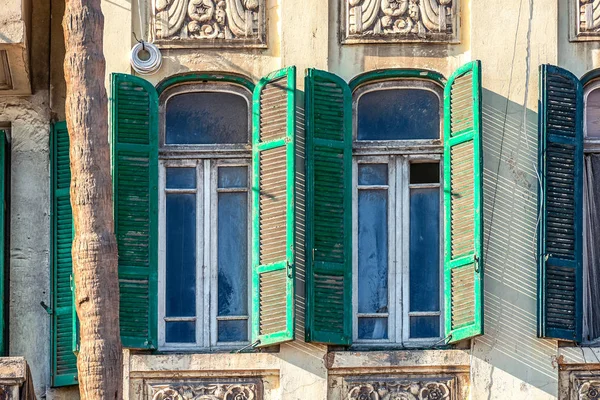 old facade with wooden windows on windows