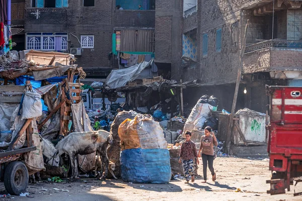 11/18/2018 Kahire, Mısır, çocuklar arasında bir sürü çöp ve kabul edilemez pis bir çöp şehrin sokakta güneşli bir günde okula