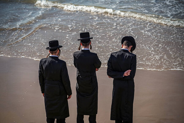 young Jews on the coast of the Mediterranean Sea in traditional dress