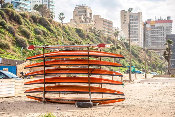 05/12/2018 Netanya, Israel, sup boards are holded on the beach of Mediterranean Sea at sunny day