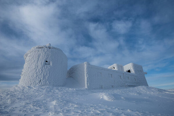 snow-covered scientific observatory on the top of the mountain on a sunny day