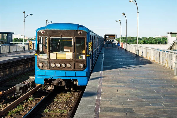 open-type Dnipro station and subway train approaching to the platform for passenger landing