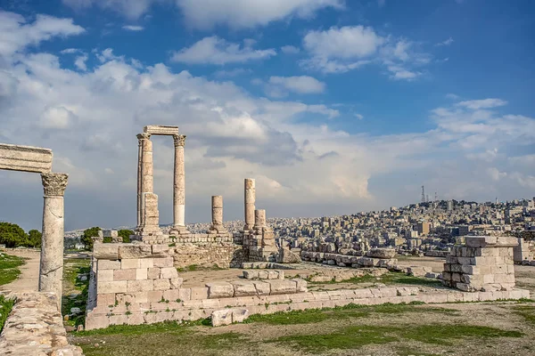 Ruins of the Temple of Hercules on the top of the mountain of the Amman citadel with a view of the ancient Middle Eastern city Stock Picture