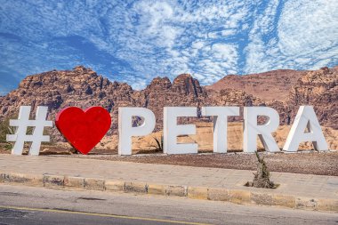 Hashtag with the inscription '' I love Petra '' on a viewing platform on the sloping view of the Petra Visitor Center clipart