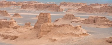 unsurpassed landscapes of sandy rocks in Dasht-e-Lut, Lut desert,hottest desert in the world, also known like Kalut Desert clipart