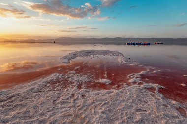 beautiful landscape and sunset with sky reflection over salty Lake Maharlu in Iran, Fars Province near Shiraz city, with incredibly red water like blood clipart