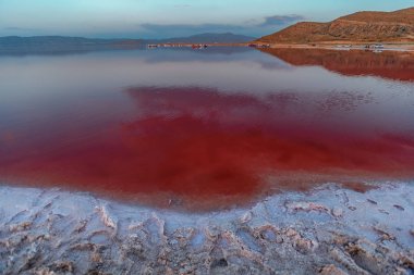 Incredible Sunset with Sky Reflection over Salty Lake Maharlu in Iran, Fars Province near Shiraz city, with incredibly rich red water like blood clipart