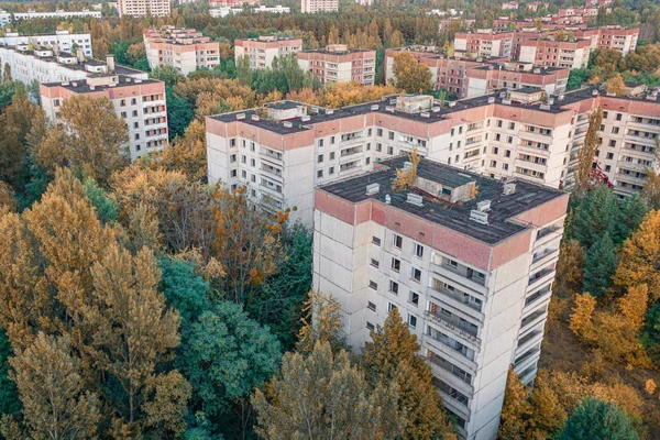 aerial view of the lost city of Pripyat. a lot of empty concrete floors overgrown with trees. Pripyat is empty after the evacuation for 33 years after the accident at the Chernobyl nuclear power plant