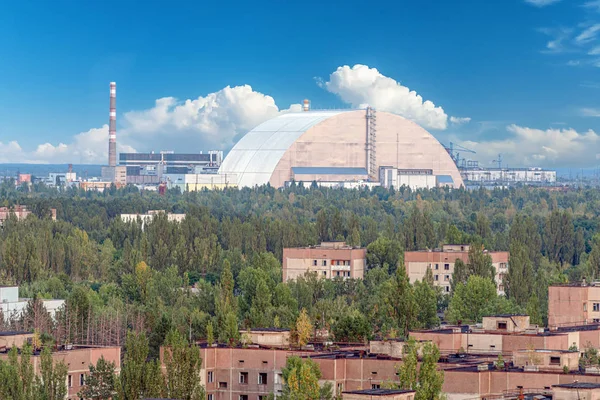 view of the new safe confinement arch with blue sky at the Chernobyl nuclear power plant through the prospect of abandoned Pripyat. NSF is a new sarcophagus for safe deactivation work