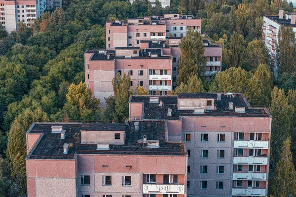 aerial view of the lost city of Pripyat. a lot of empty concrete floors overgrown with trees. Pripyat is empty after the evacuation for 33 years after the accident at the Chernobyl nuclear power plant