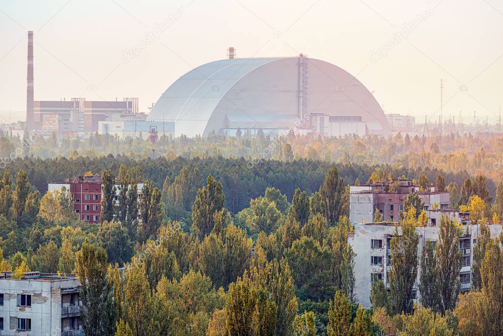 view of the new safe confinement arch at sunrise above Chernobyl nuclear power plant through the prospect of abandoned Pripyat. NSF is a new sarcophagus for safe deactivation work