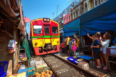 02.02.2020 Tayland, Samut Songkhrami, Mae Klong demiryolu pazarı Siang Tai olarak da bilinir. Turistler tren rayları boyunca yürür ve yaklaşan trenin fotoğraflarını ve selfielerini çekerler. Dünyanın her yerinden gelen turistler arasında popüler bir yer.
