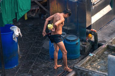 08 / 01 / 2020 Hindistan, Mumbai, Adam Dhobi Ghat 'te duş alıyor. Mahalaxmi Dhobi Ghat olarak da bilinir. Mumbai' deki en büyük açık hava çamaşırhanesidir..