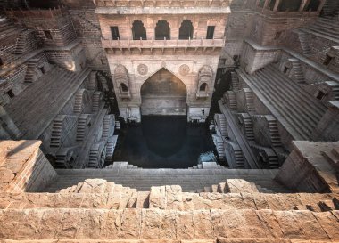 Toorji Ka Jhalra Bavdi world famous step well in Jodhpur, Rajasthan, India. Stepwells in which the water is reached by descending a set of steps to the water level clipart