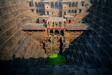 Perspective stone stairs of the famous and deepest Chand Baori Step Well in Abhaneri, Rajasthan, India. Stepwells in which the water is reached by descending a set of steps to the water level clipart