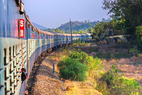 India, Maharashtra, Perspective view and curve of Indian train at the dawn. Indian trains are the cheapest way to travel around India