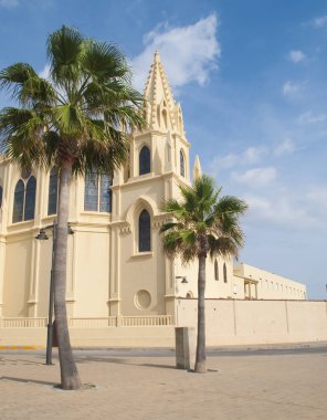 Chipiona İspanyol köyü bulunan regla Meryem Kilisesi güneşli bir palmiye ağacı ile sarı bir kilise olduğunu 