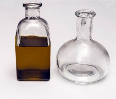 Beyaz arka planla çevrili bir şişe zeytinyağı.