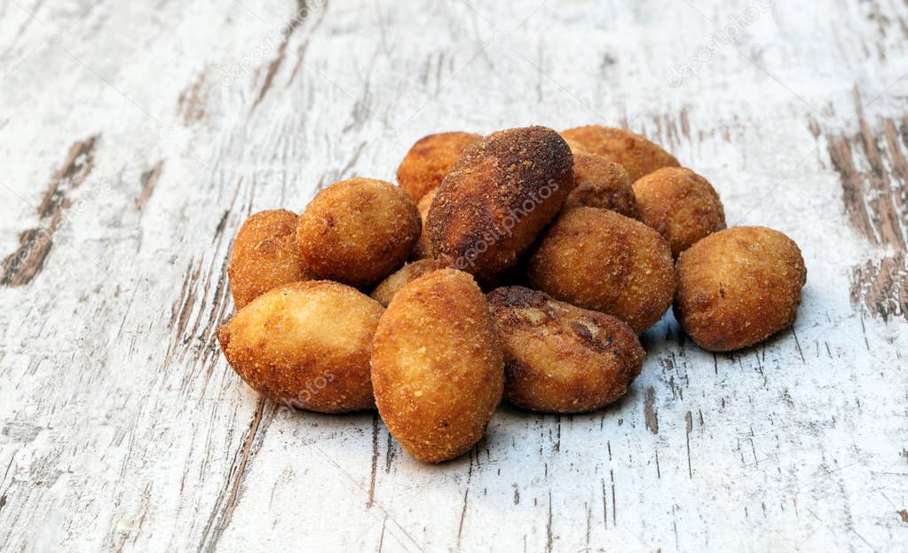 Croquettes surrounded by rustic background