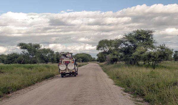 AMBOSELI, Kenya - MAY 2014. Tourist in jeep safari in the road of National Park of Kenya. They are traying see animals.