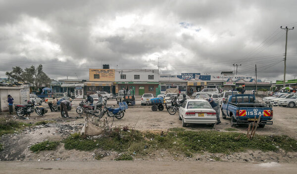 NAIVASHA, KENYA - MAY, 2014: Typical shopping street scene with pedestrians in Naivasha, Kenya