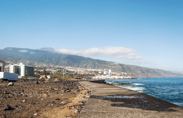 Waves breaking along the rocks in Tenerife, in the Canary Islands on a sunny day.
