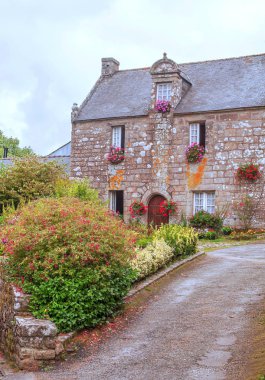 Bulutlu bir günde taş evleriyle şatoulin. Fransa 'nın Brittany kentinde yer almaktadır..