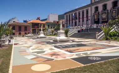 LA OROTAVA CANARY ISLAND SPAIN - JUNE 2018. The people of the town working on the day of Corpus Christi in the flower carpets. clipart