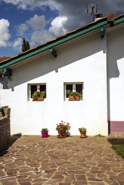 Bulutlu bir günde İspanya Navarra Pyrenees dağlarda alanları ile orman evi.