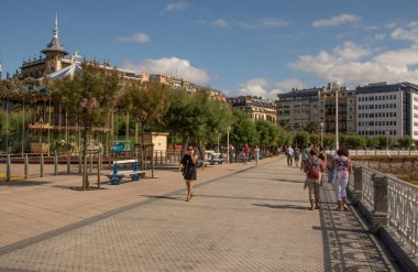 SAN SEBASTIAN, SPAIN - SEPTEMBER 2018. Streets next to the beach of La Concha in San Sebastian with people walking in them.