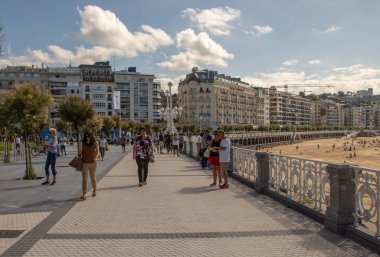 SAN SEBASTIAN, SPAIN - SEPTEMBER 2018. Streets next to the beach of La Concha in San Sebastian with people walking in them.