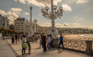 SAN SEBASTIAN, SPAIN - SEPTEMBER 2018. Streets next to the beach of La Concha in San Sebastian with people walking in them.