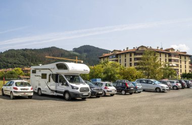 Zumaya, Spain-September 2018. Parking for cars and motorhomes in the spanish basque country on a sunny day clipart
