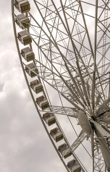 Fair ferris wheel in the central square of Budapest in a cloudy day.