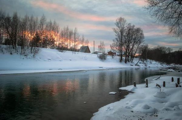Nehir ve ağaçlarla kaplı kış manzarası