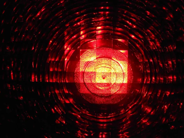 close-up of illuminated red signal lamp, safety installation at construction site at night