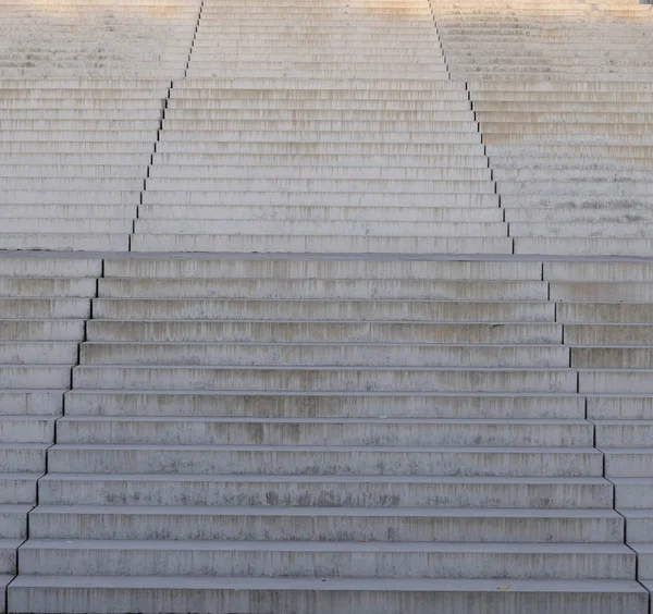 broad white concrete steps of a large outdoor stairway in a city