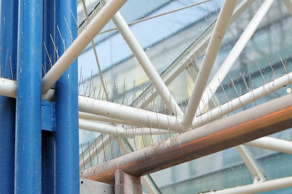 linkage of a modern pavilion in pedestrian zone of a city with bird control spikes