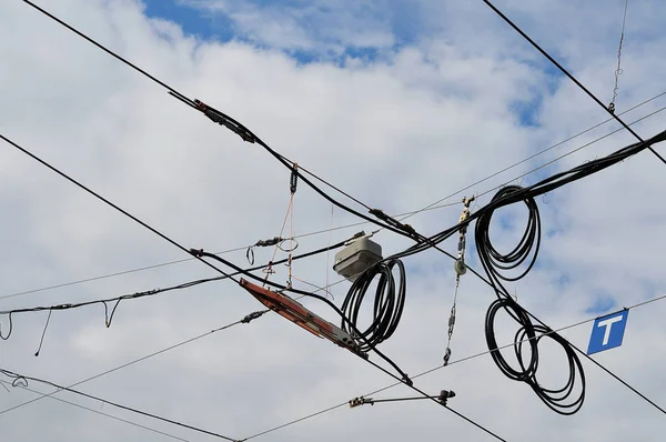 crossing overhead power supply lines for a tramway under construction with black cables